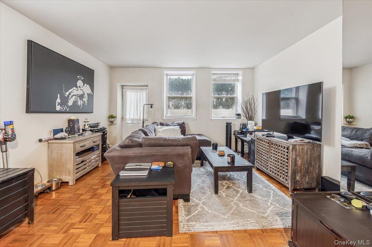 1250 North Avenue, Unit 115 New Rochelle, NY 10804 - Photo 3 of 16 a living room with furniture and a flat screen tv