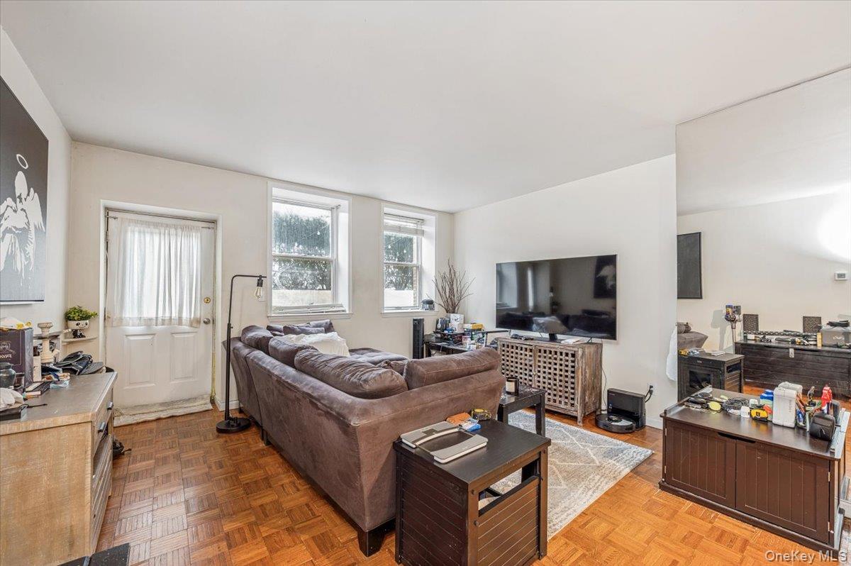 1250 North Avenue, Unit 115 New Rochelle, NY 10804 - Photo 5 of 16 a living room with furniture or couch and a flat screen tv