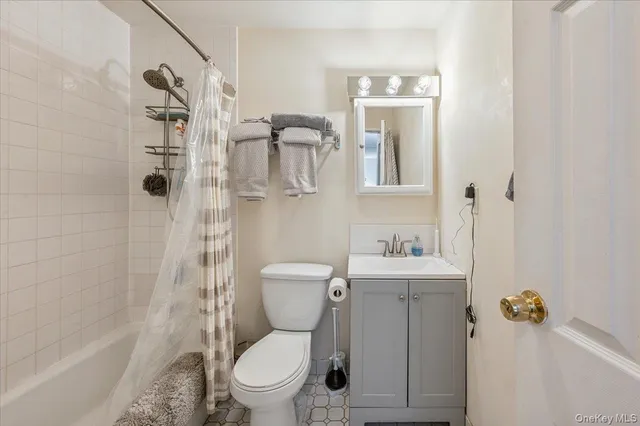 a white toilet sitting next to a bathroom sink