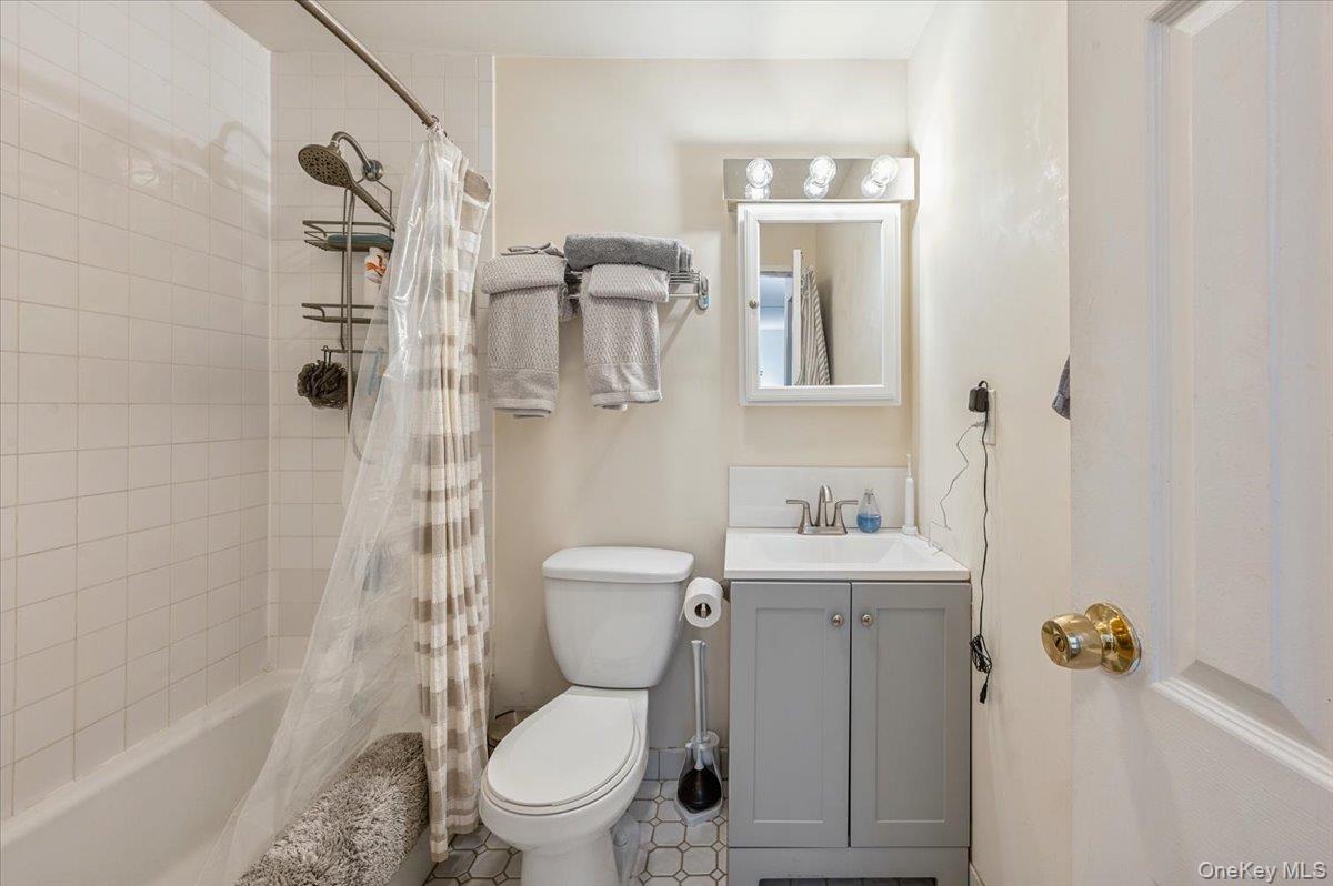 1250 North Avenue, Unit 115 New Rochelle, NY 10804 - Photo 7 of 16 a white toilet sitting next to a bathroom sink