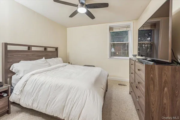 a bedroom with a bed and window