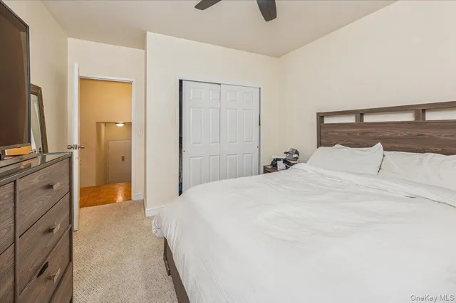 a spacious bedroom with a bed and a flat screen tv