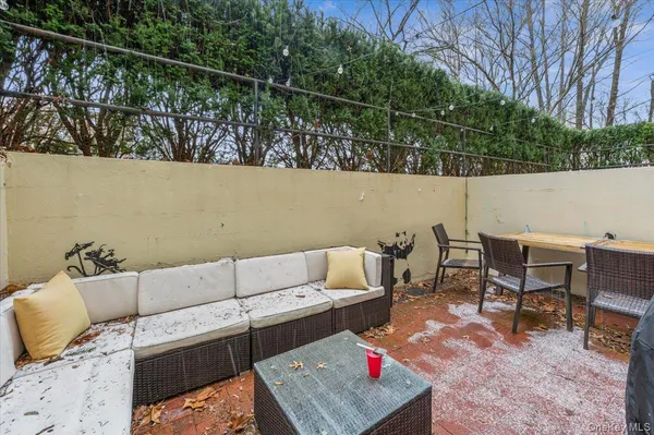 a terrace of a house with outdoor seating