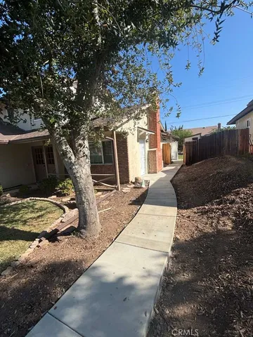 a row of palm trees in front of a house