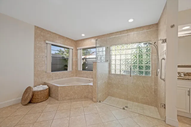 a bathroom with a tub sink and mirror