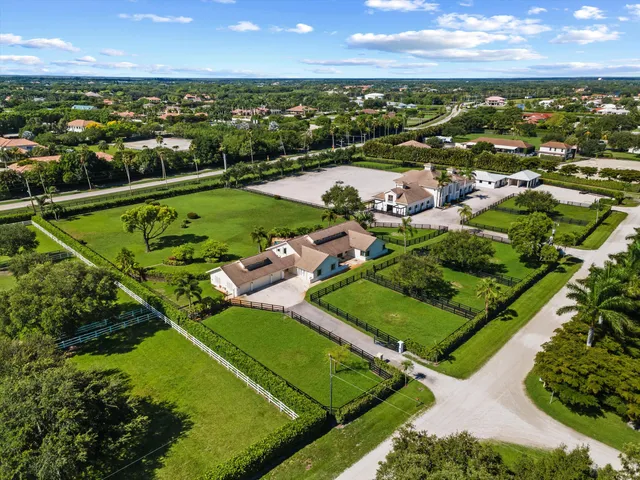 an aerial view of a tennis ground and a houses