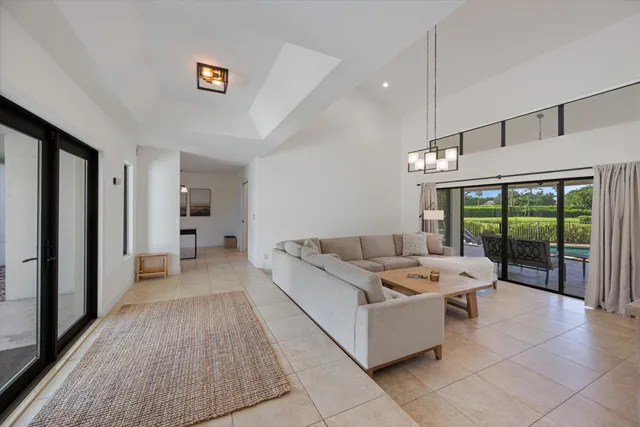 a living room with furniture and large windows