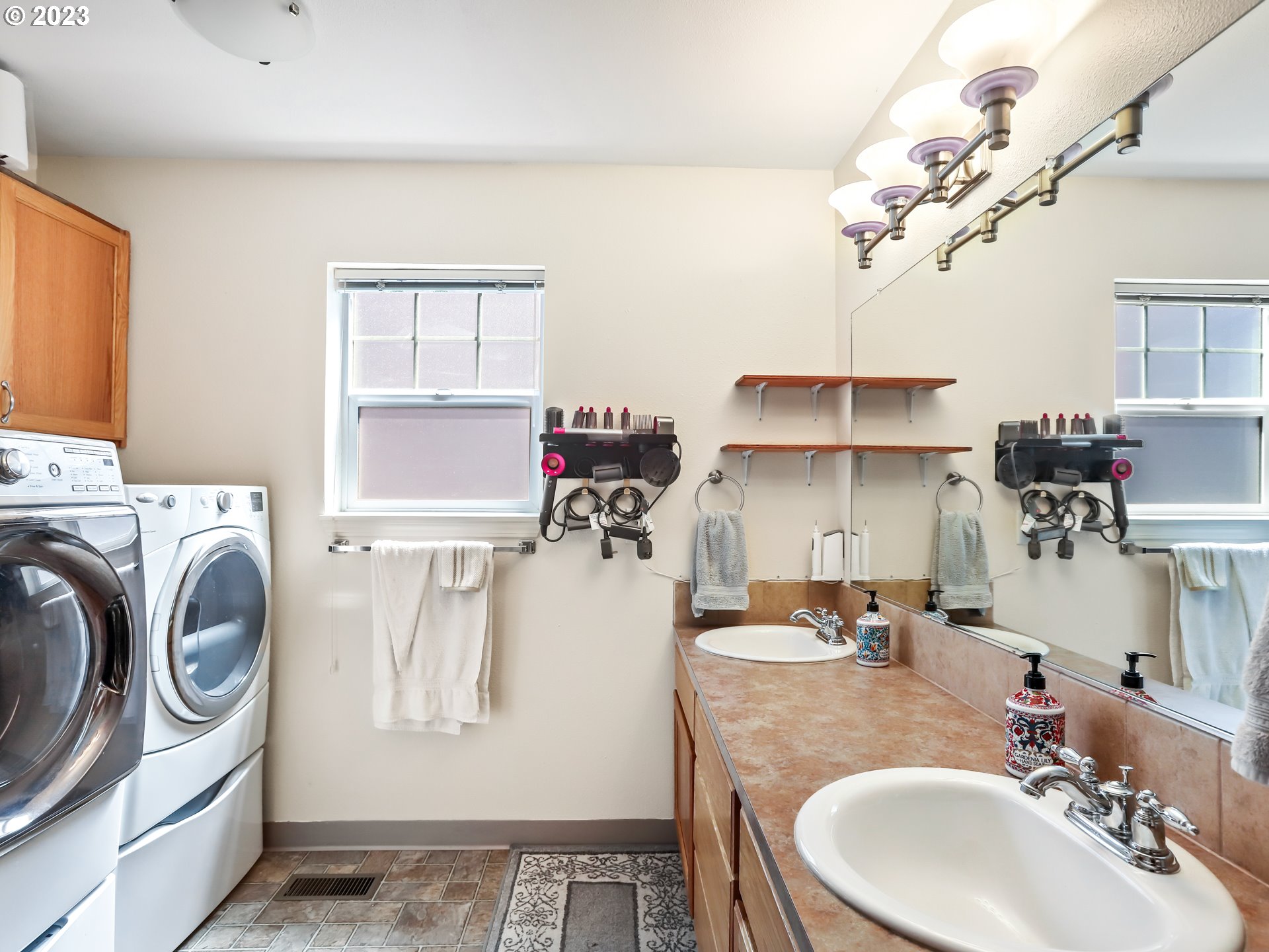 18533 Southwest Deloris Lane Beaverton, OR 97007 - Photo 18 of 43 a bathroom with a sink a washer and dryer