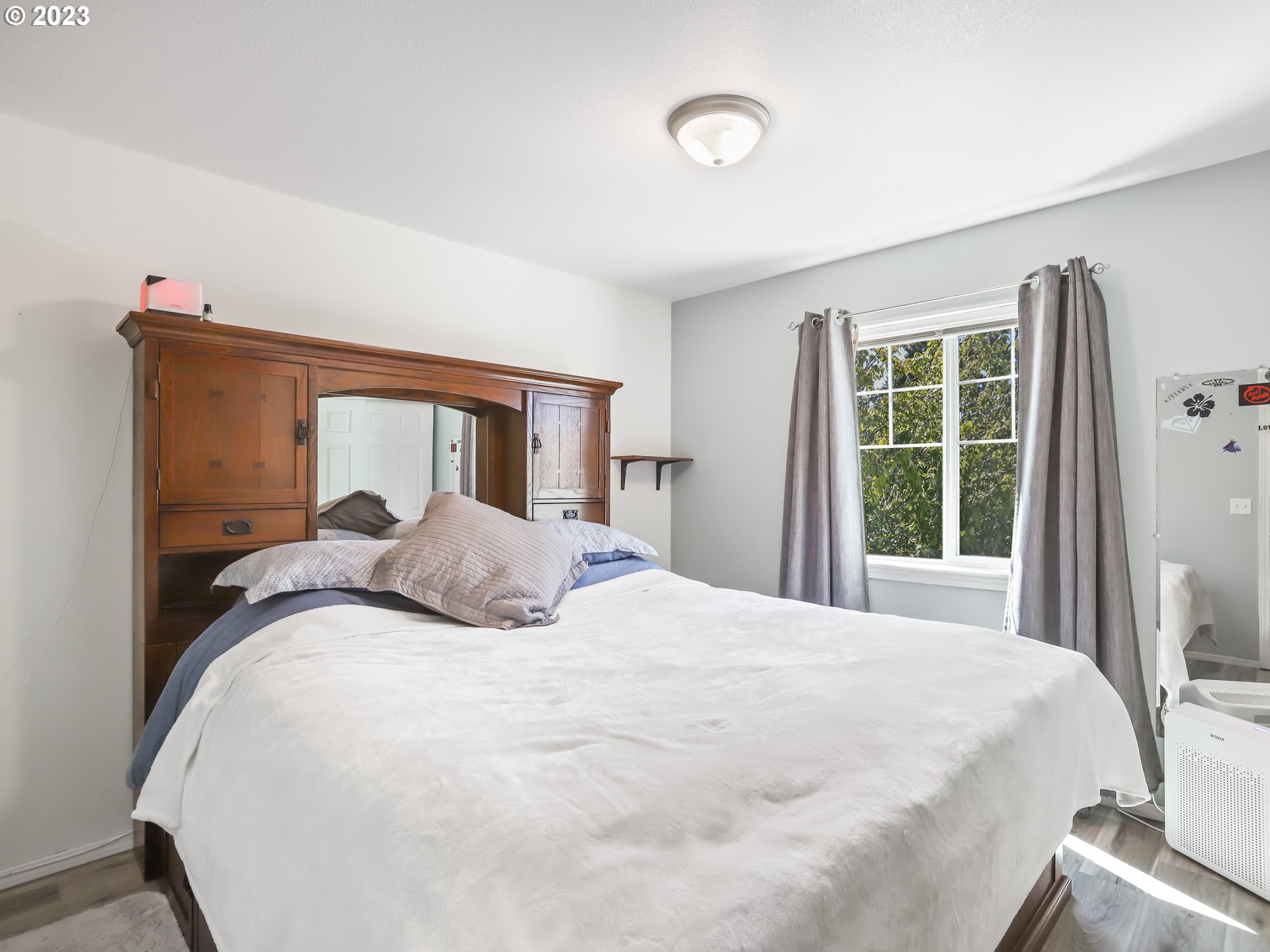 18533 Southwest Deloris Lane Beaverton, OR 97007 - Photo 23 of 43 a bedroom with a large bed and a large window