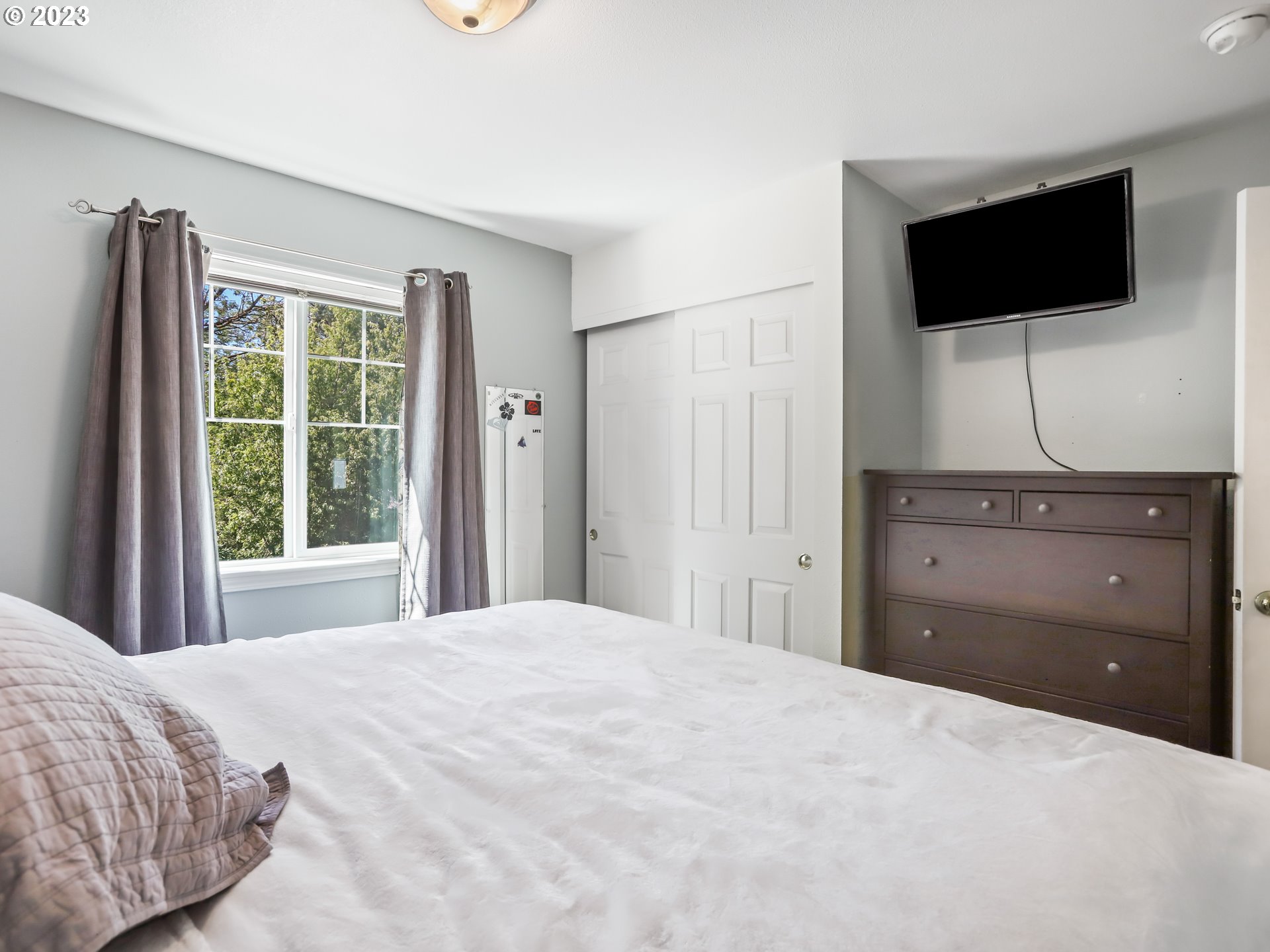 18533 Southwest Deloris Lane Beaverton, OR 97007 - Photo 25 of 43 a bedroom with a bed and a flat screen tv