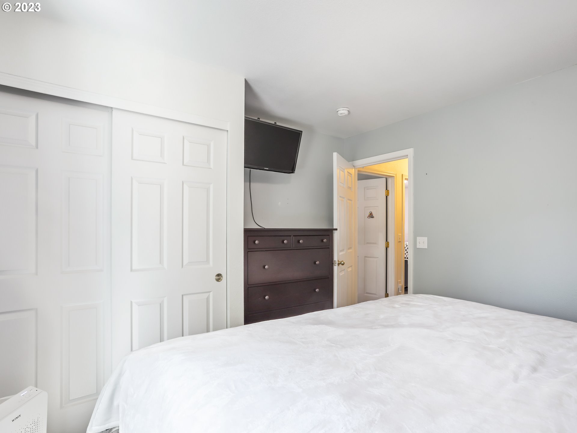 18533 Southwest Deloris Lane Beaverton, OR 97007 - Photo 26 of 43 a bedroom with a bed and a flat screen tv