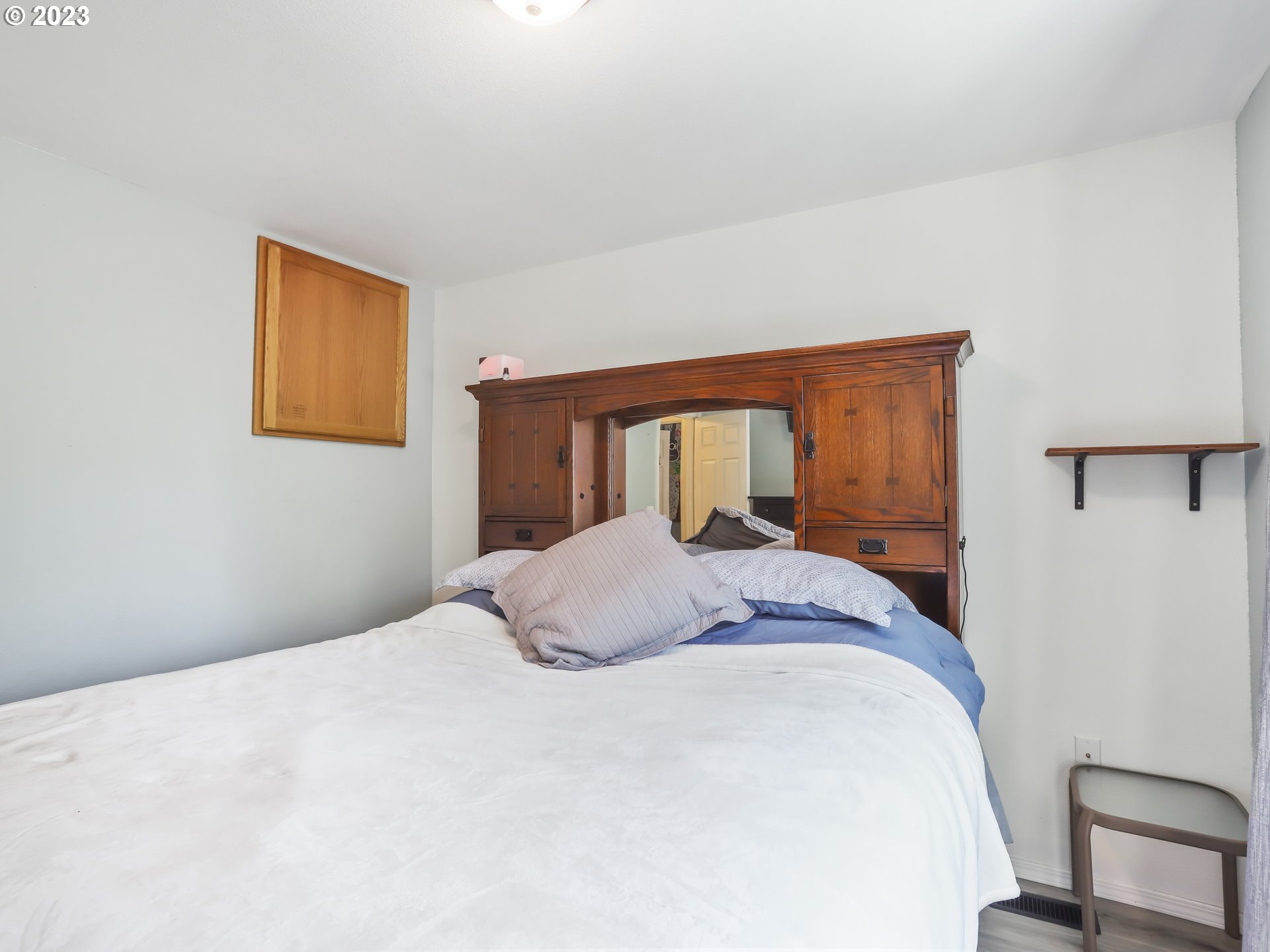 18533 Southwest Deloris Lane Beaverton, OR 97007 - Photo 27 of 43 a bedroom with a bed and a painting on the wall