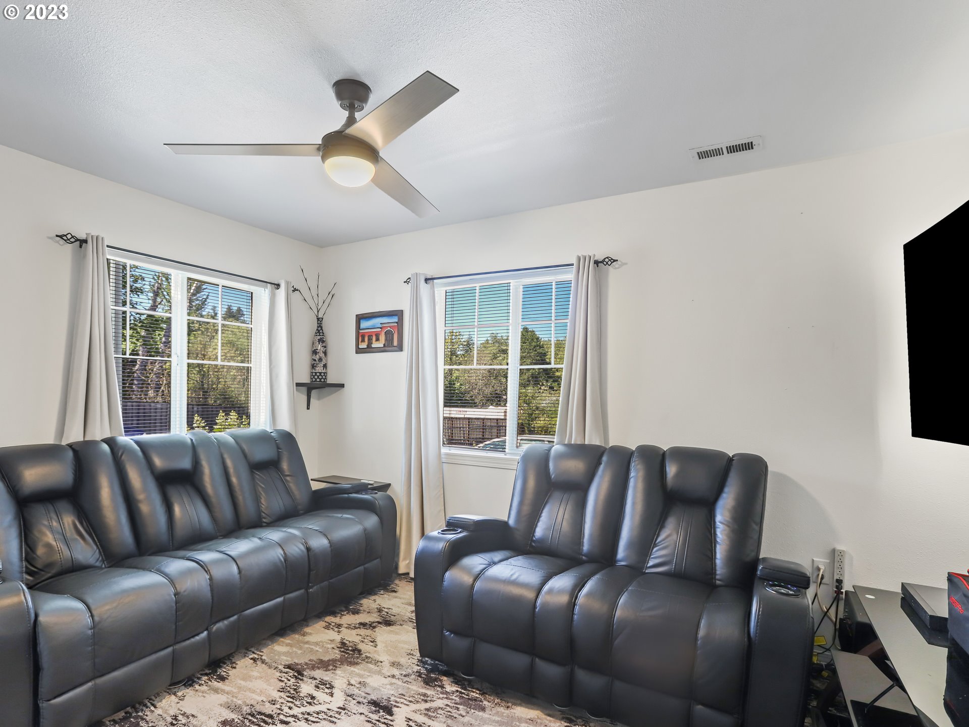 18533 Southwest Deloris Lane Beaverton, OR 97007 - Photo 4 of 43 a living room with furniture window and flat screen tv