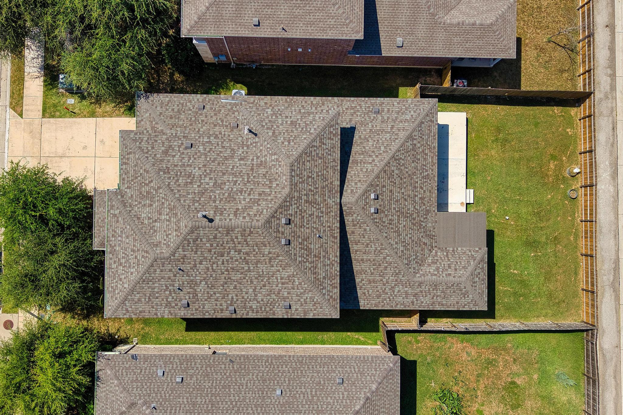 1341 Eagle Ray Street Leander, TX 78641 - Photo 32 of 37 An aerial perspective reveals the well-maintained shingle roof and surrounding neighborhood green spaces.