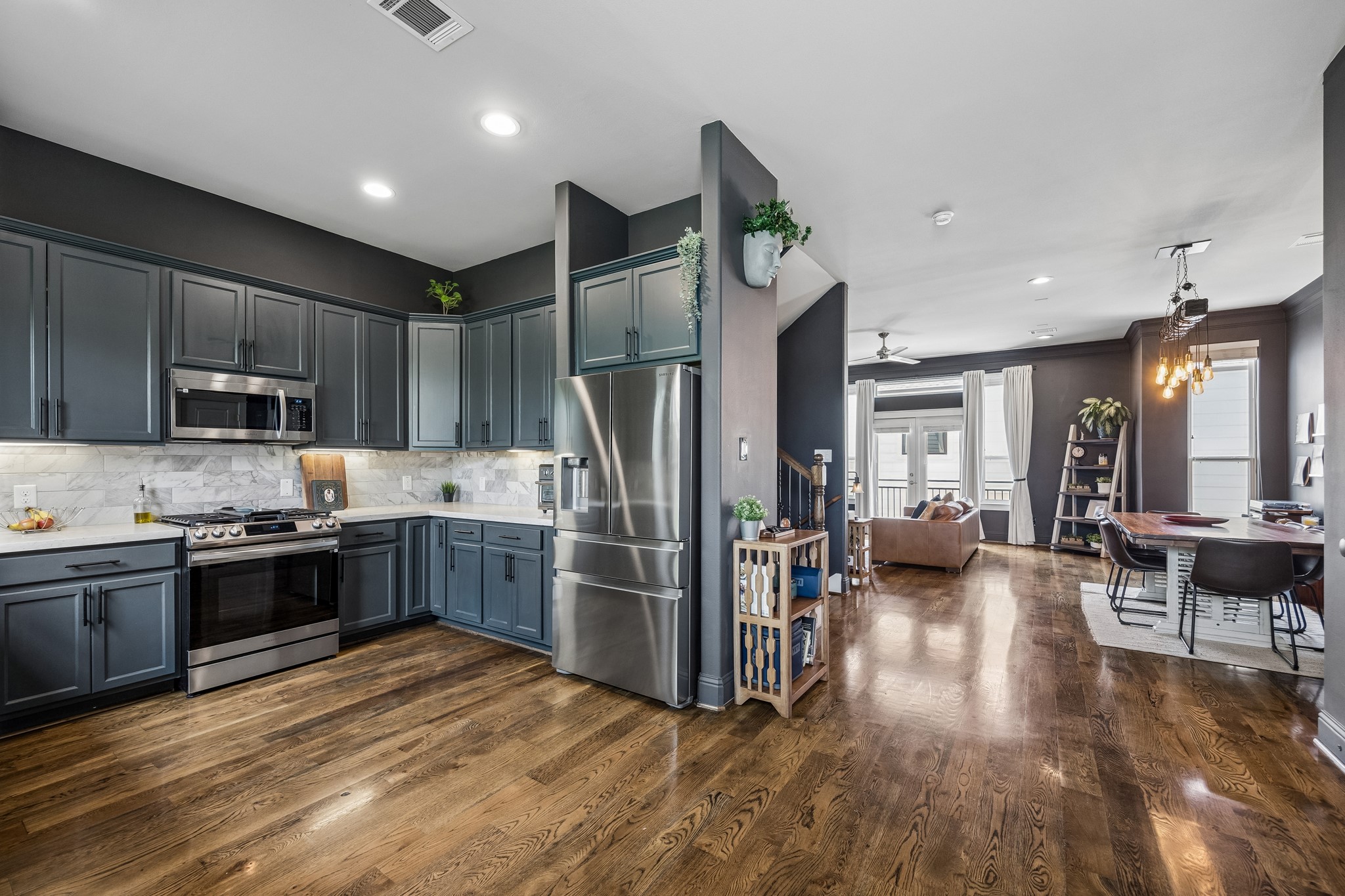 624 East 28th Street Houston, TX 77008 - Photo 12 of 34 a kitchen with stainless steel appliances granite countertop a refrigerator a stove top oven a sink dishwasher and wooden cabinets with wooden floor