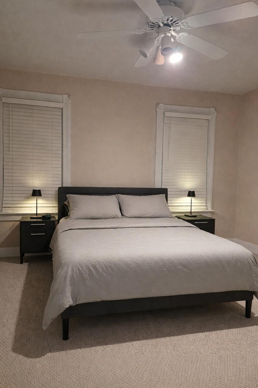 321 West Main Street Millville, NJ 08332 - Photo 11 of 23 a bedroom with a bed and a chandelier