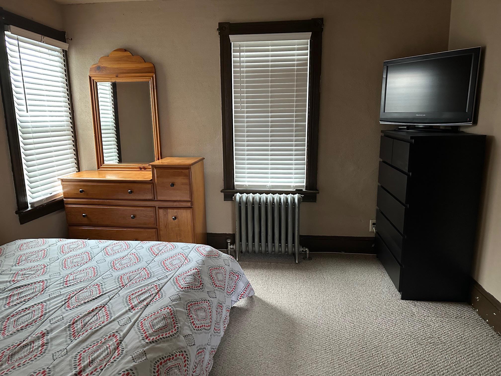 321 West Main Street Millville, NJ 08332 - Photo 13 of 23 a bedroom with a bed and a flat tv screen on dresser