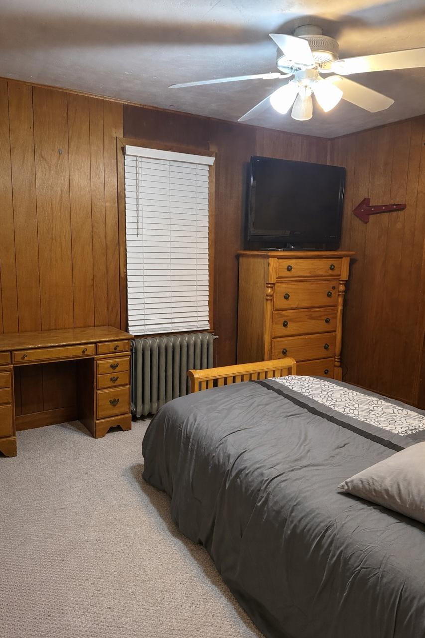 321 West Main Street Millville, NJ 08332 - Photo 14 of 23 a bedroom with a bed and a flat tv screen on dresser