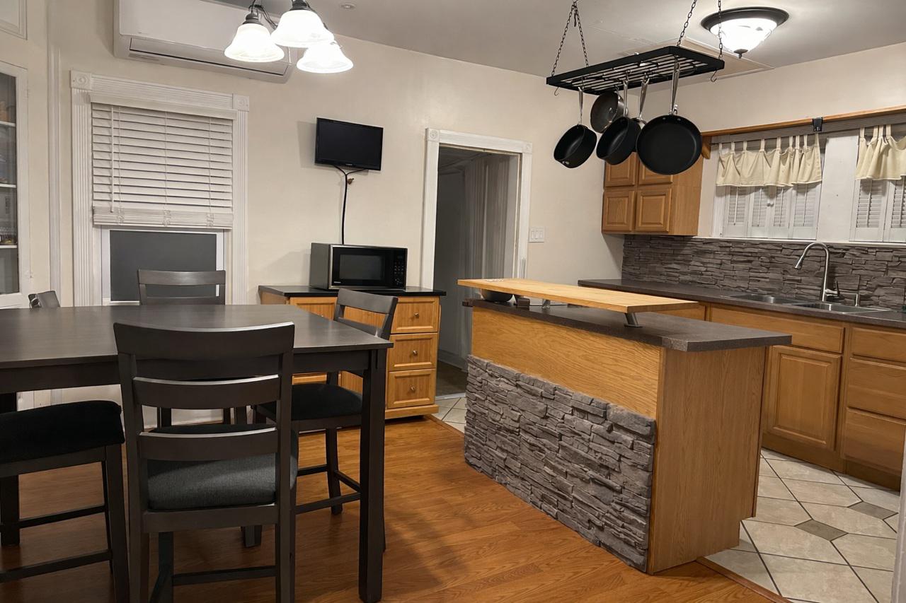 321 West Main Street Millville, NJ 08332 - Photo 7 of 23 a kitchen with a stove a chandelier and a refrigerator