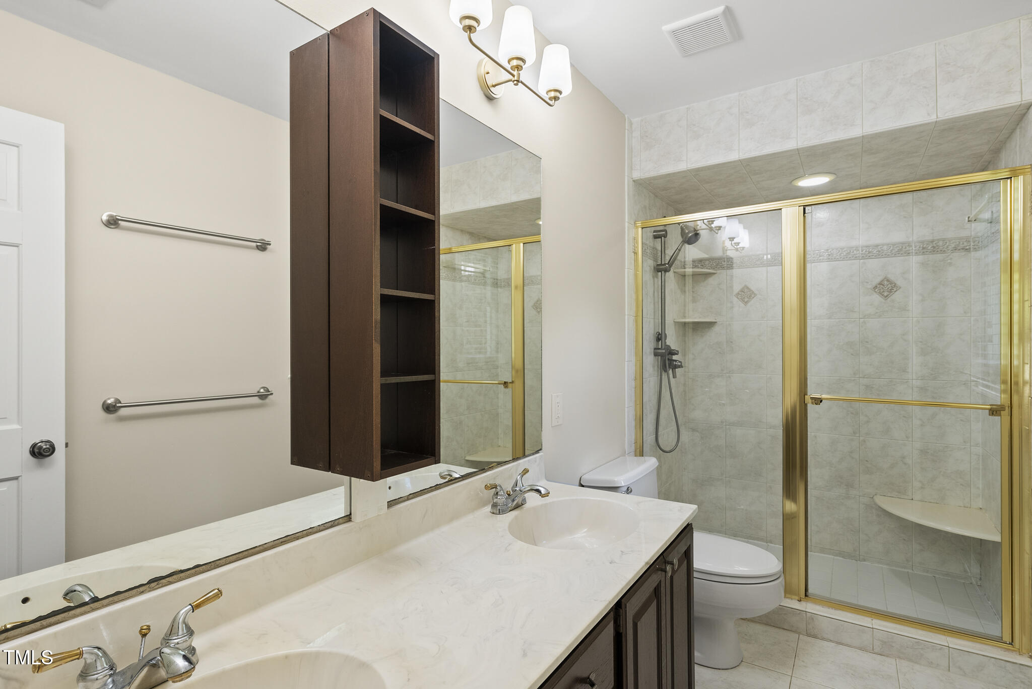8716 Mourning Dove Road Raleigh, NC 27615 - Photo 14 of 44 a bathroom with a sink and a mirror