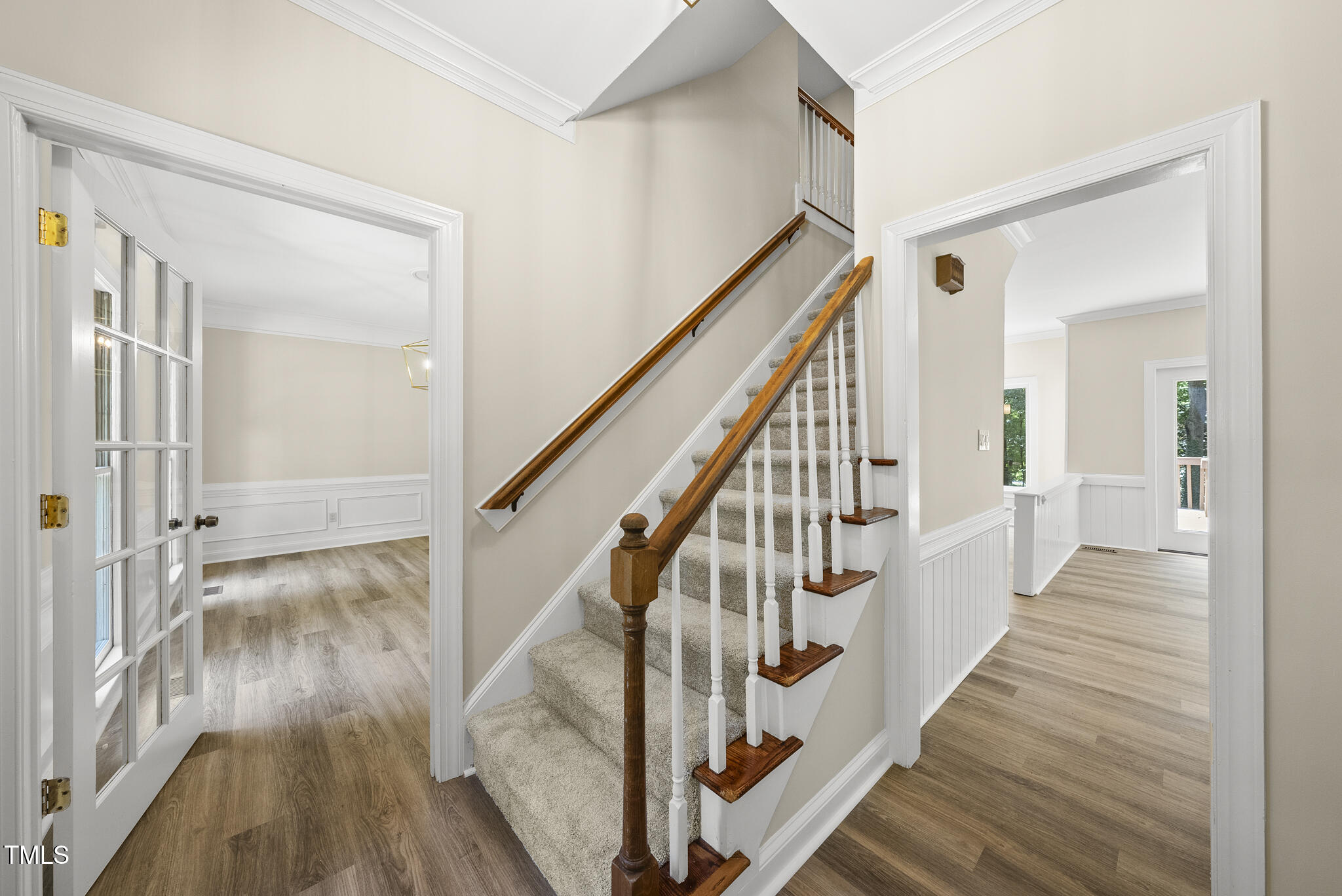 8716 Mourning Dove Road Raleigh, NC 27615 - Photo 2 of 44 a view of a hallway with wooden floor and staircase