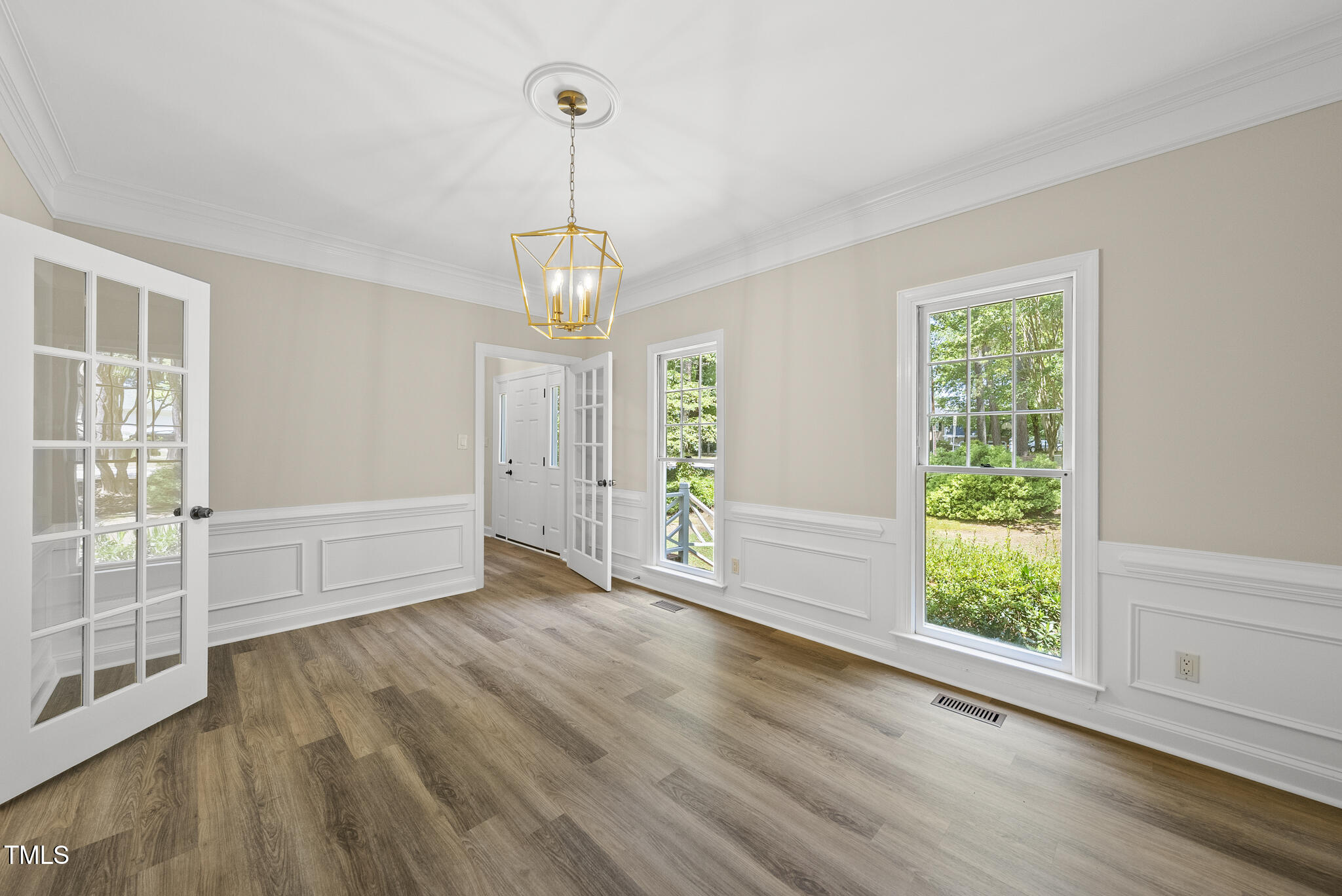 8716 Mourning Dove Road Raleigh, NC 27615 - Photo 3 of 44 a view of empty room with wooden floor and fan