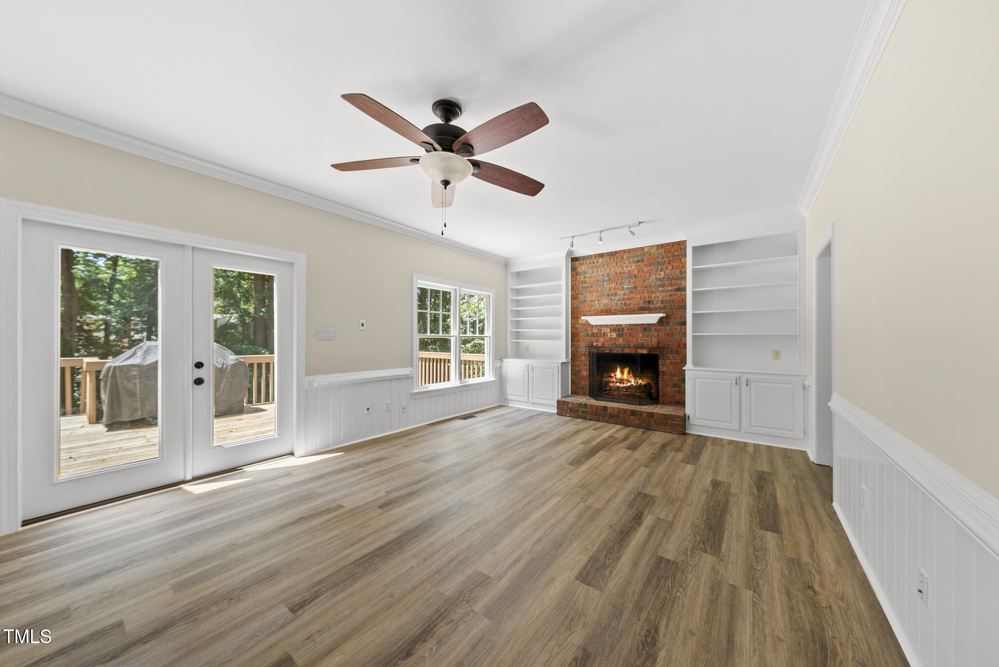 8716 Mourning Dove Road Raleigh, NC 27615 - Photo 5 of 44 a view of an empty room with wooden floor and a window