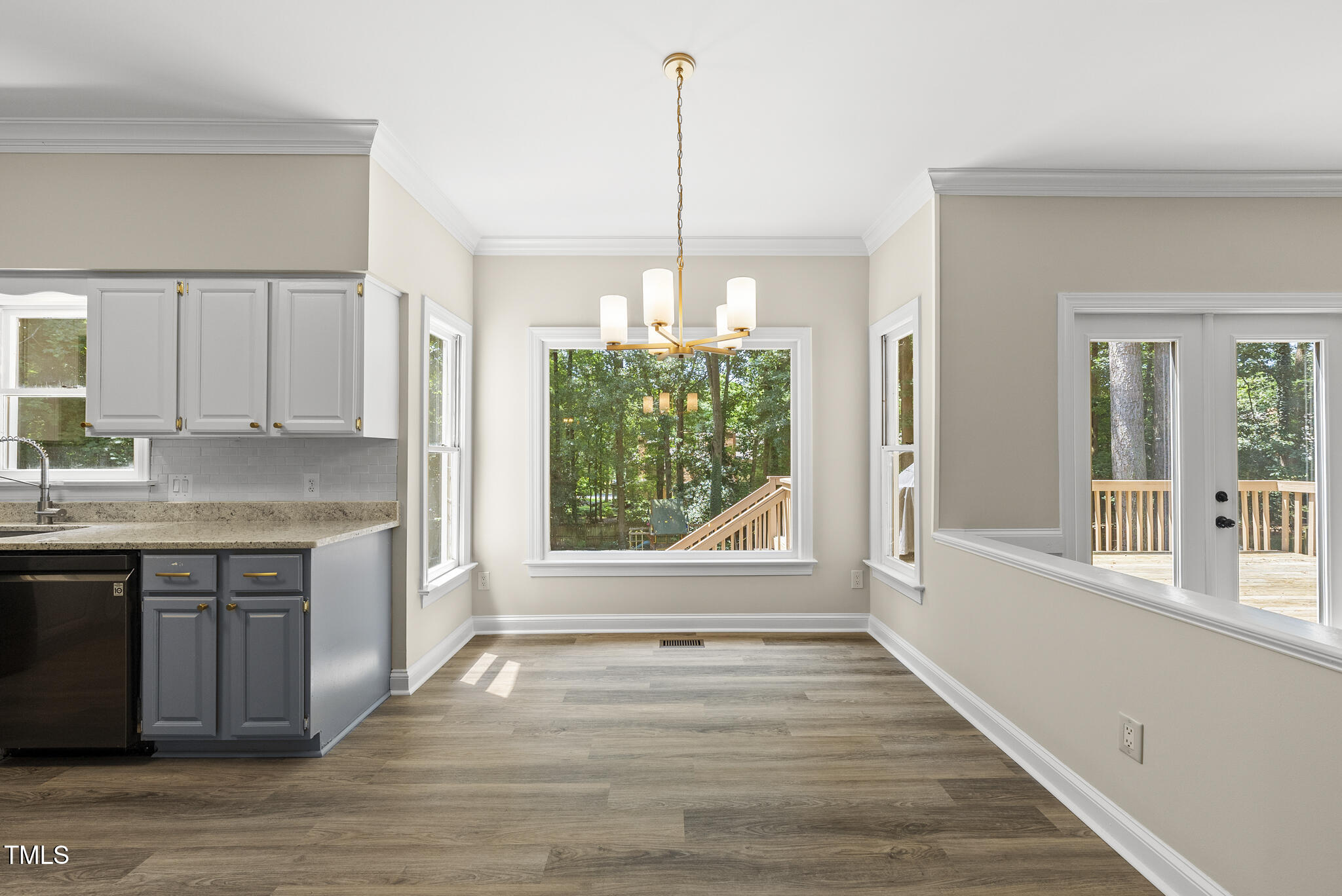 8716 Mourning Dove Road Raleigh, NC 27615 - Photo 8 of 44 a view of a kitchen cabinets a sink and wooden floor