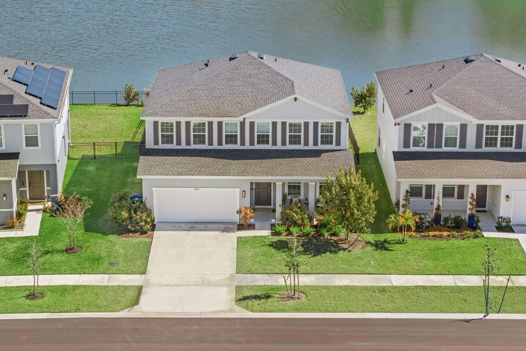 12297 Southwest Forli Way Port Port St. Lucie, FL 34987 - Photo 1 of 37 a front view of a house with a yard