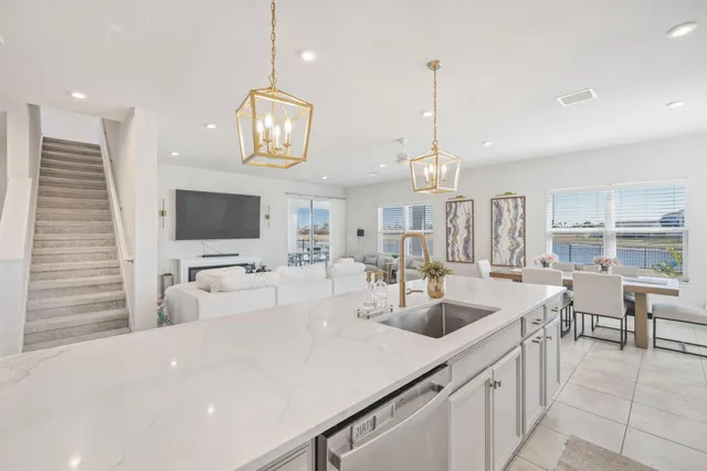 a bathroom with a sink a faucet a potted plant and a shower