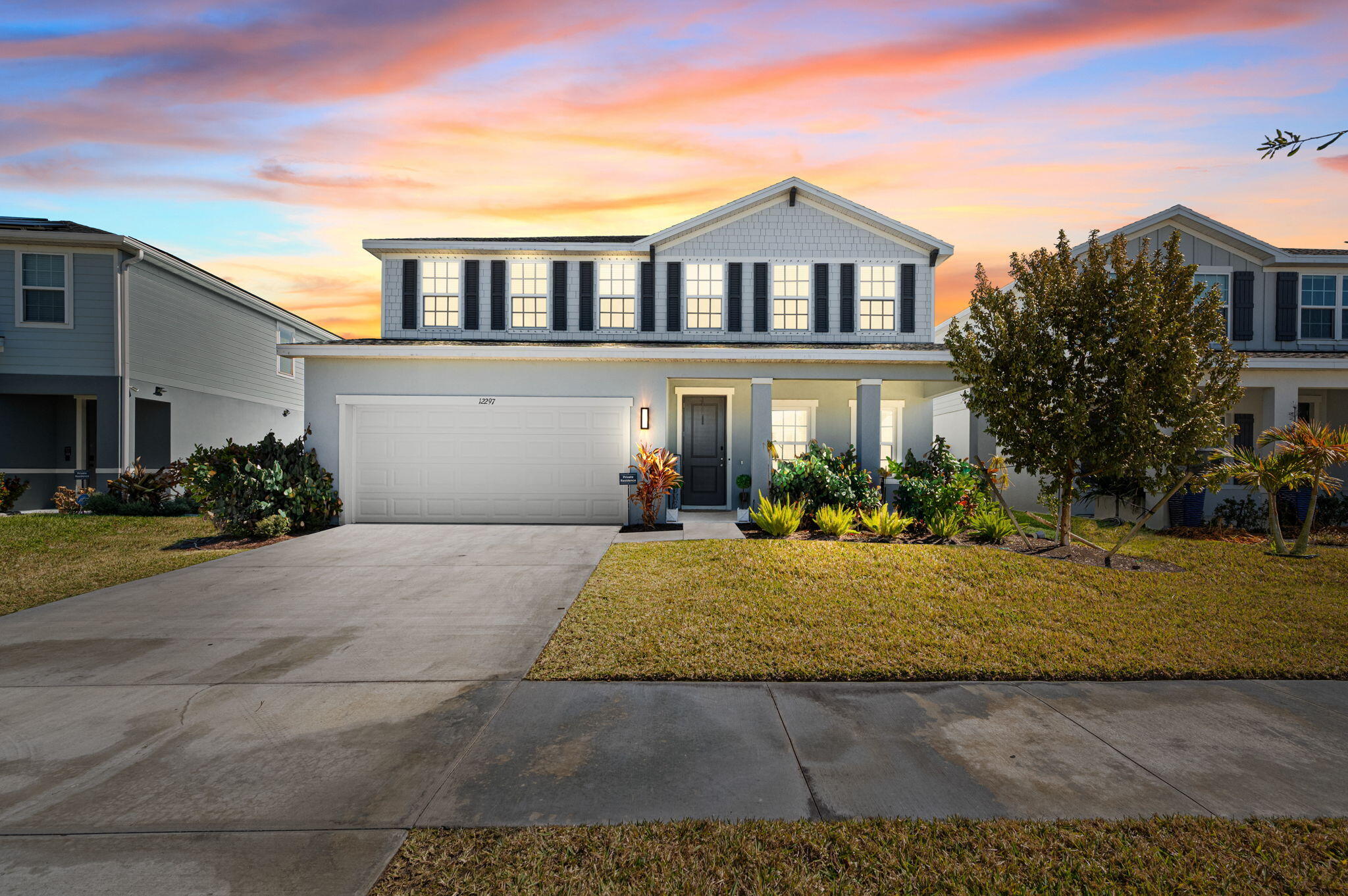 12297 Southwest Forli Way Port Port St. Lucie, FL 34987 - Photo 3 of 37 a front view of a house with garden