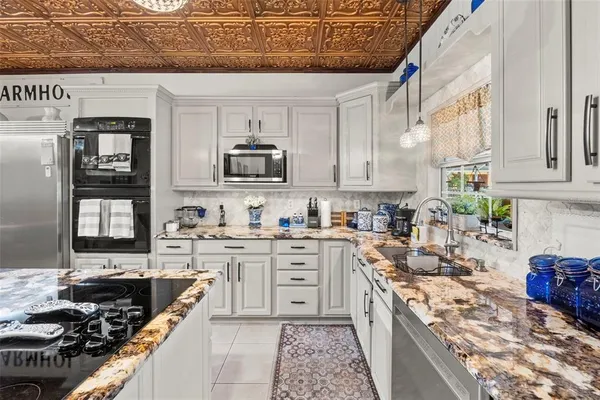 a living room with a baby crib furniture a mirror and a window