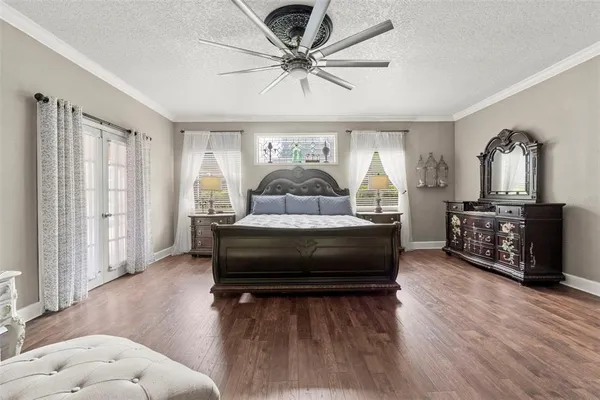 a bedroom with a bed and a chandelier