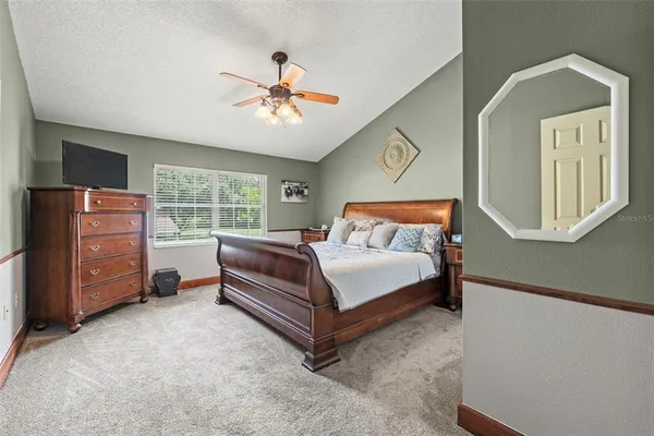 an aerial view of a house with a yard and lake view