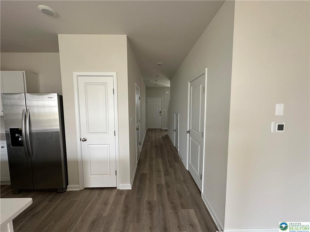 1145 Martin Road Breinigsville, PA 18031 - Photo 25 of 38 A well-lit corridor with rich wood-look flooring leads to an inviting entry.