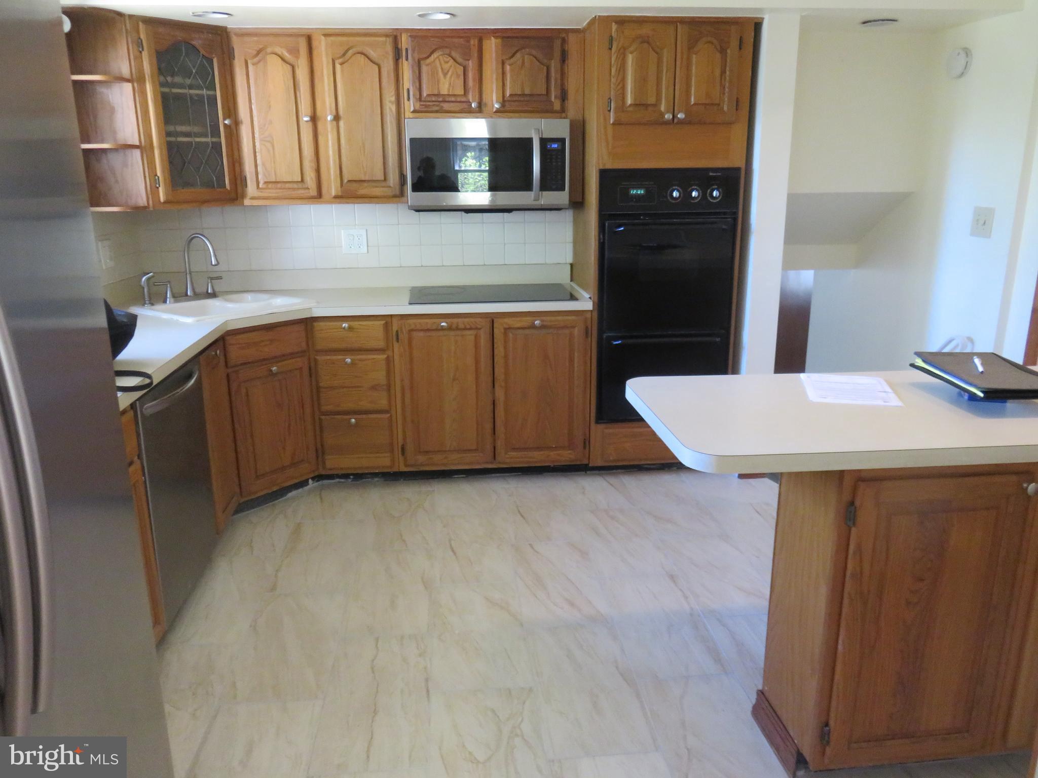 86 Kings Highway North Cherry Hill, NJ 08034 - Photo 14 of 22 a kitchen with stainless steel appliances a sink stove and refrigerator