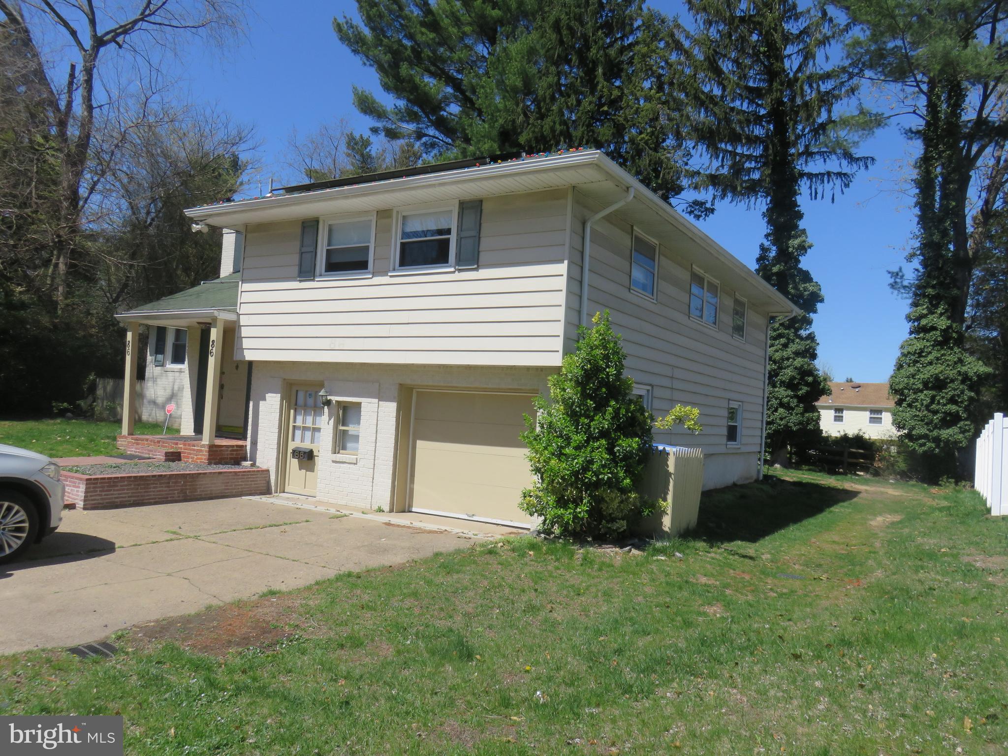 86 Kings Highway North Cherry Hill, NJ 08034 - Photo 2 of 22 a front view of a house with a garden