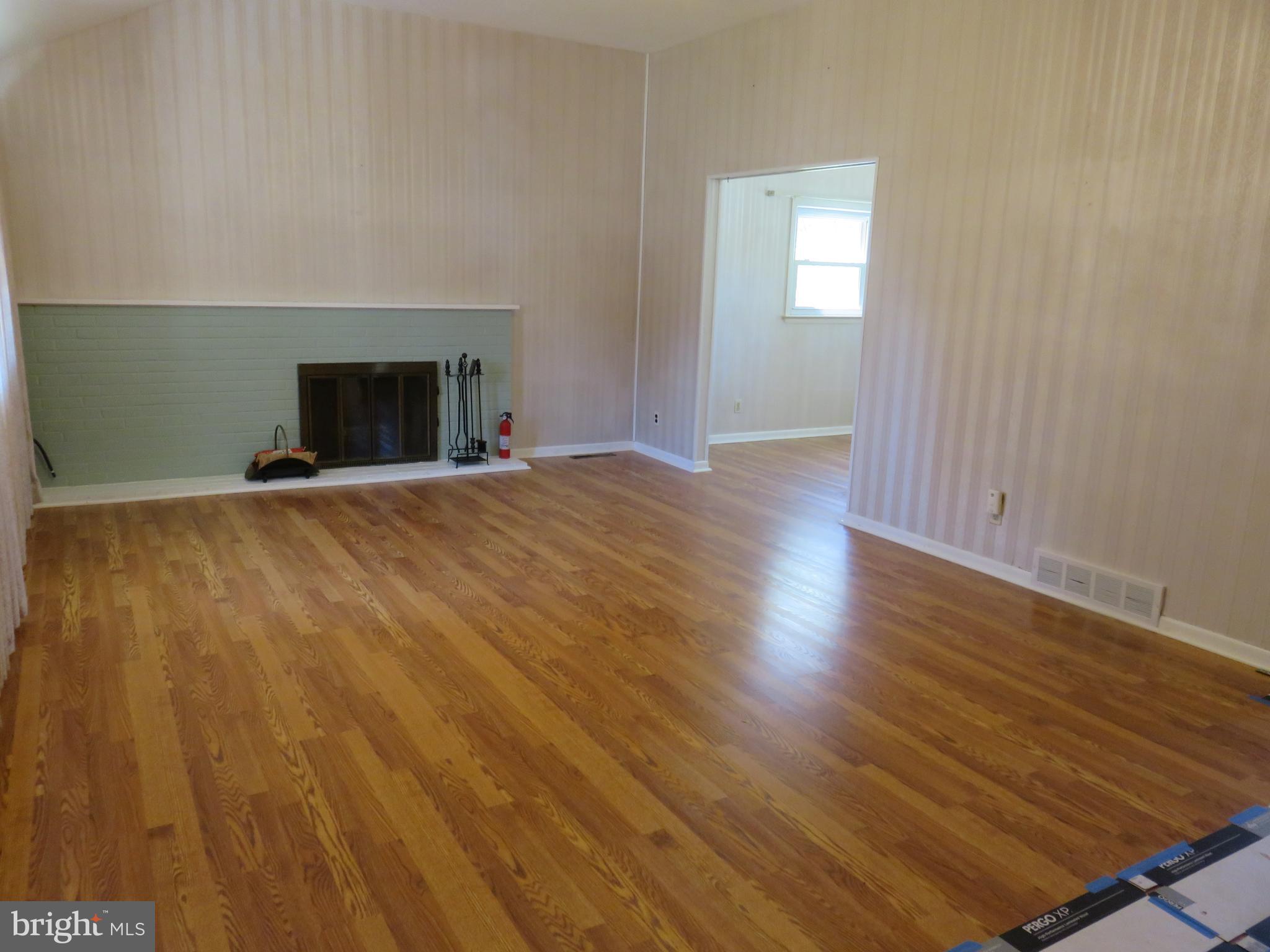 86 Kings Highway North Cherry Hill, NJ 08034 - Photo 5 of 22 an empty room with wooden floor and fireplace