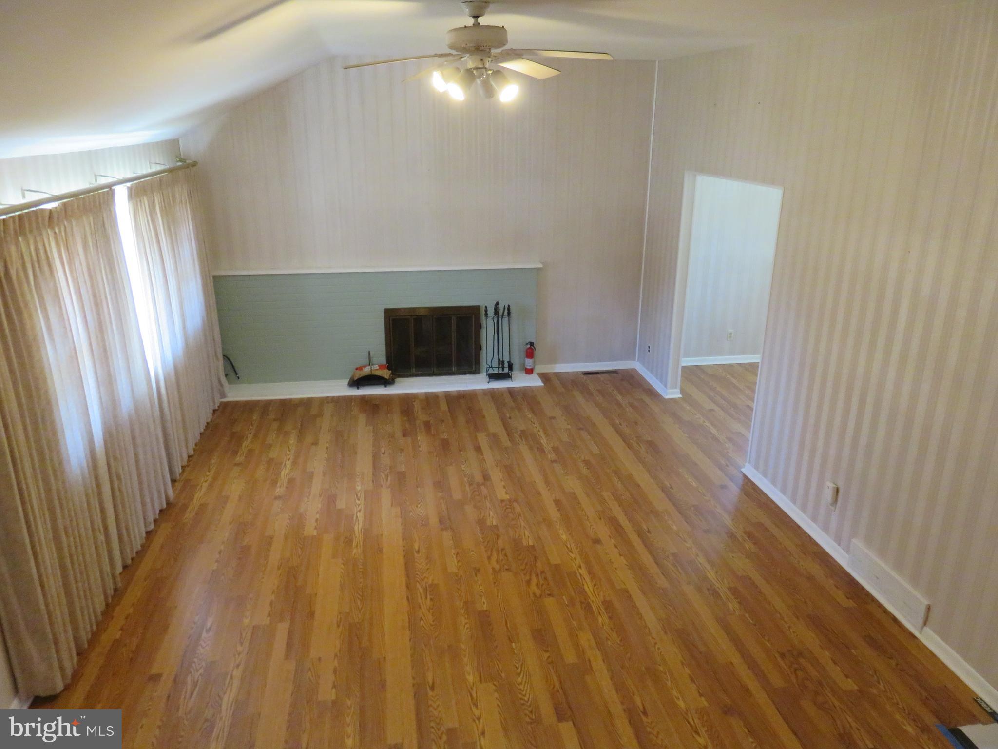 86 Kings Highway North Cherry Hill, NJ 08034 - Photo 6 of 22 a view of an empty room with wooden floor and a window