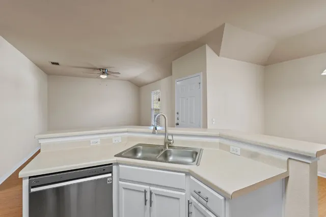 a kitchen with a sink cabinets and appliances
