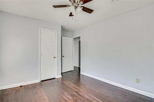 a view of an empty room with a ceiling fan