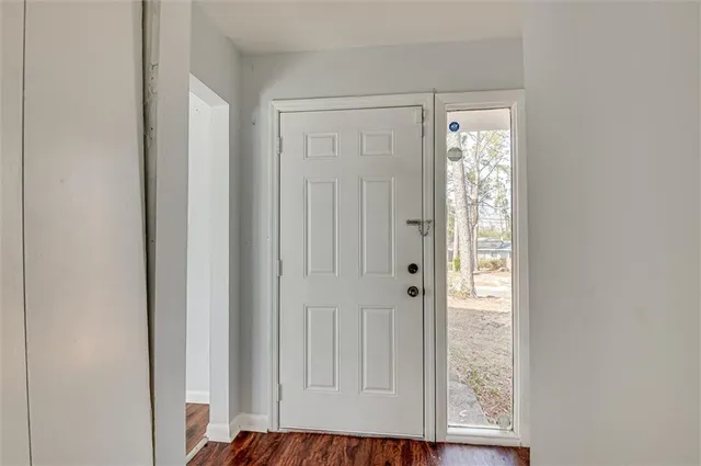 a view of front door with wooden floor