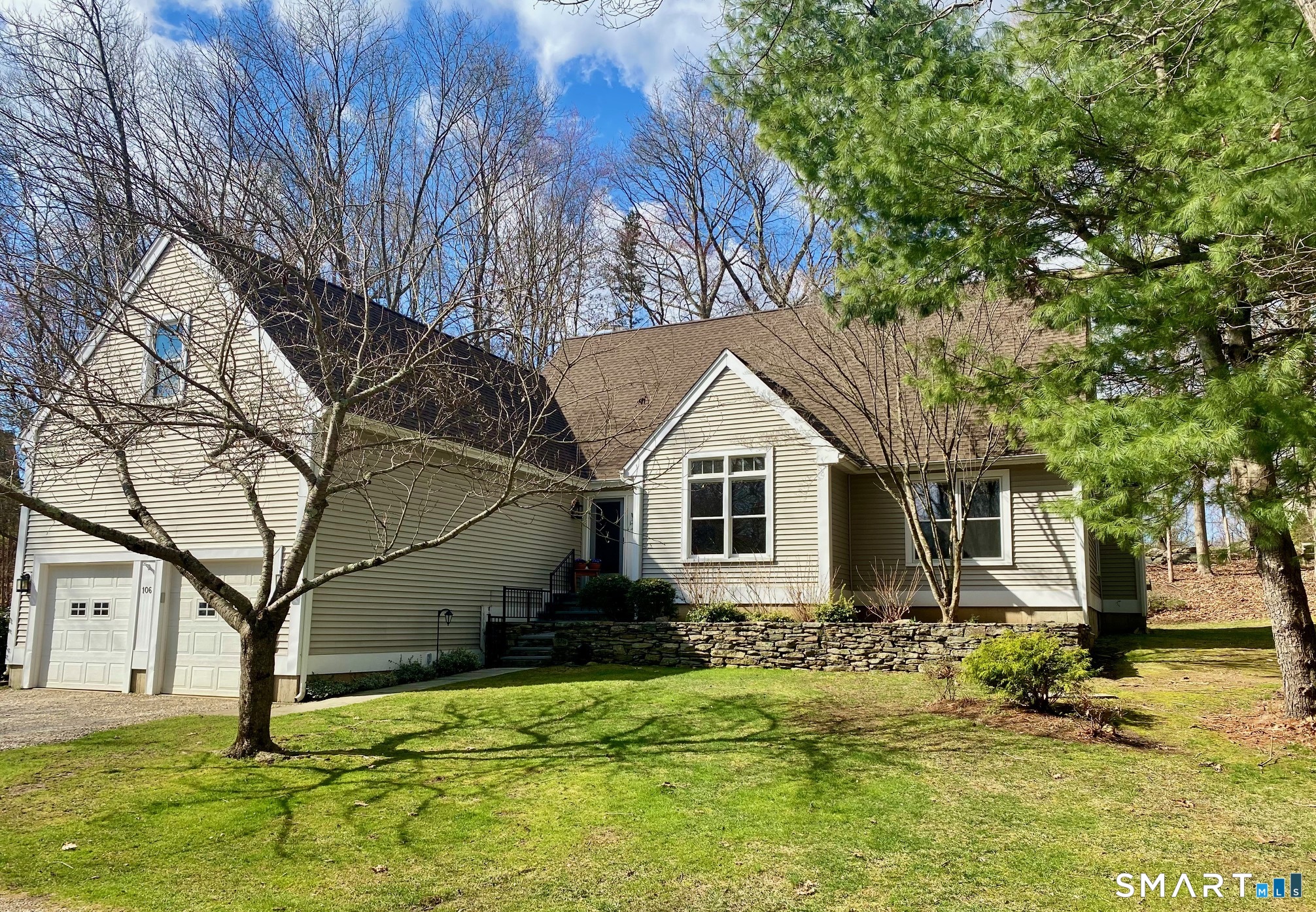 a front view of house with yard and trees