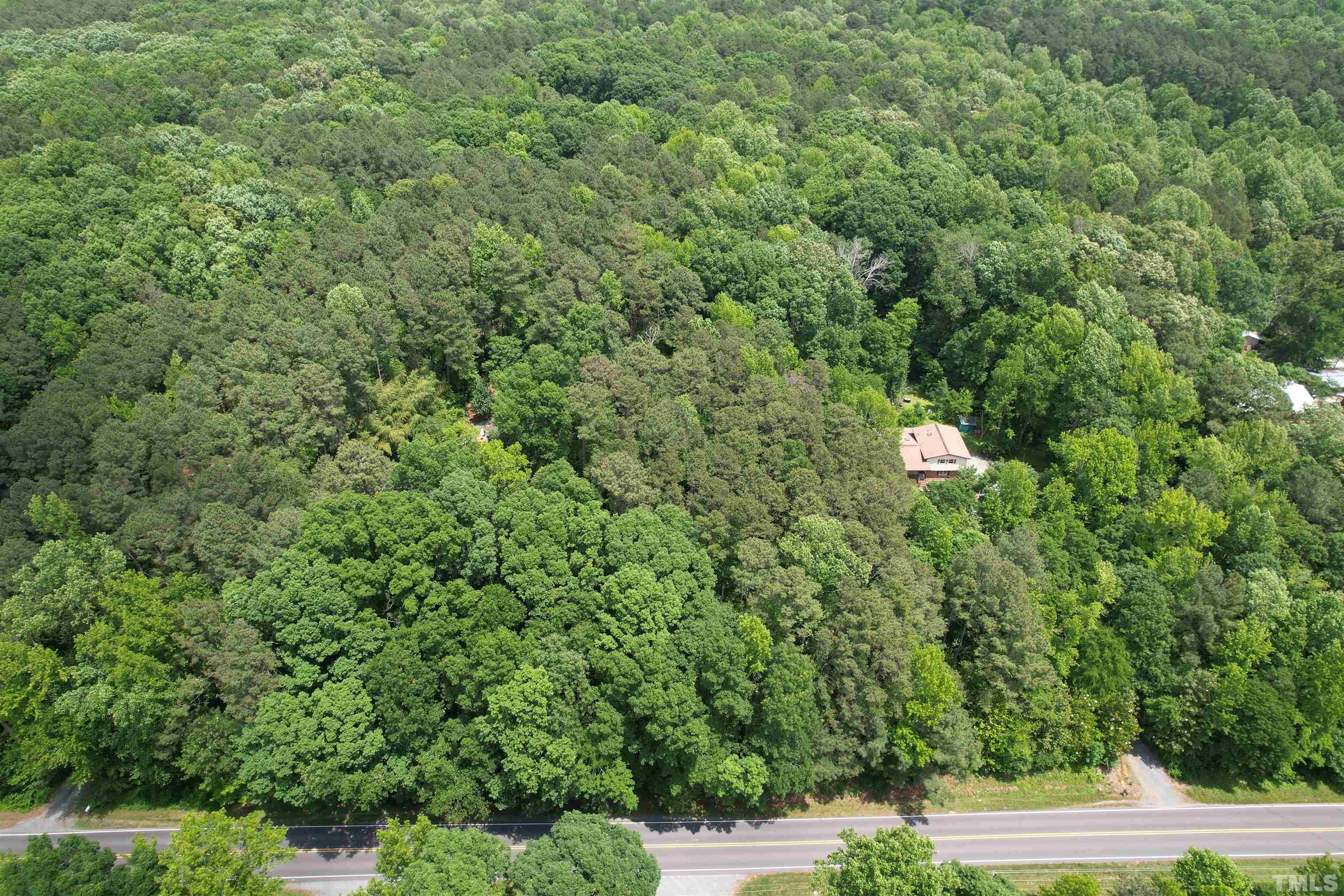 Tbd2 Hamlets Chapel Road Pittsboro, NC 27312 - Photo 9 of 10 a view of a house with a yard and tree s