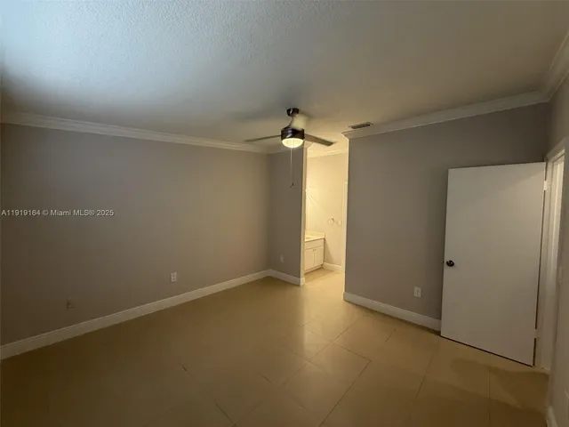 an empty room with a empty space and a ceiling fan