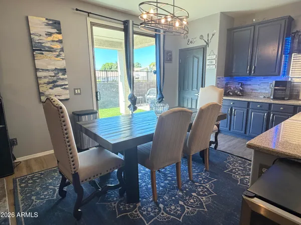 a view of a dining room with furniture wooden floor and chandelier