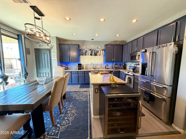 a kitchen with kitchen island a wooden floor and refrigerator