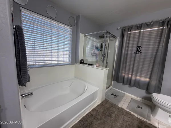 a white bath tub sitting next to a shower