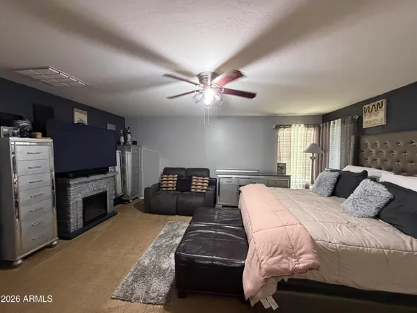 a bedroom with a bed and a television