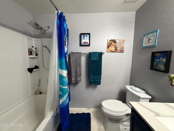 a white toilet sitting next to a bath tub